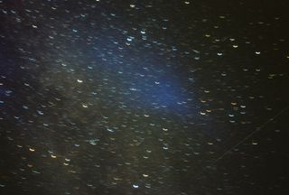 Short streaks of starlight across a dark blue night sky.