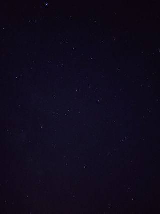 A dark night sky scattered with faint stars.